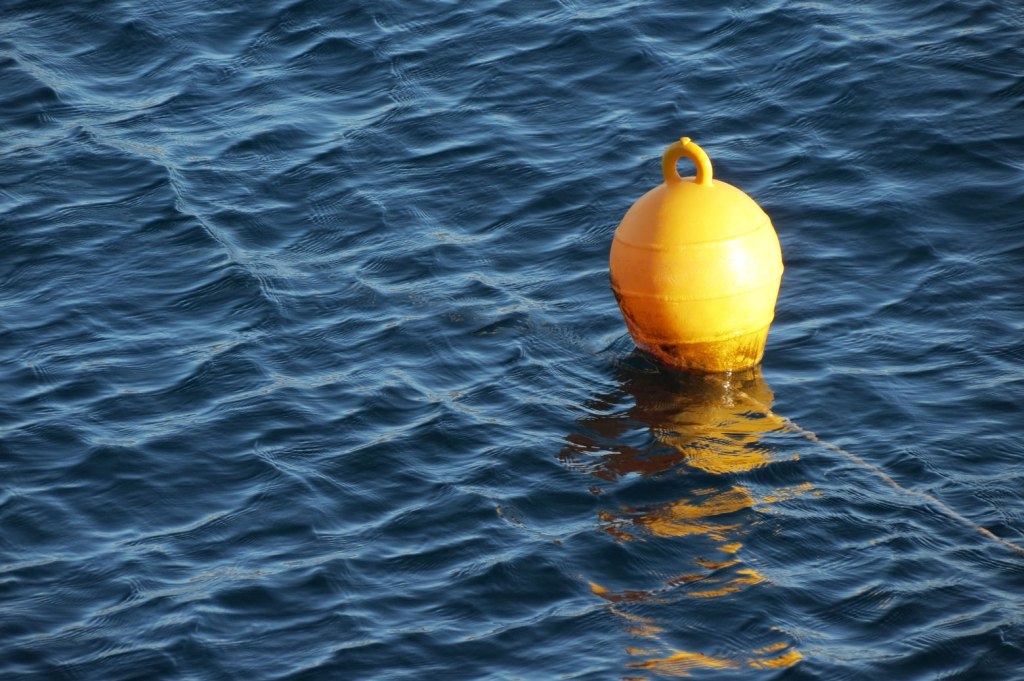yellow buoy in blue sea